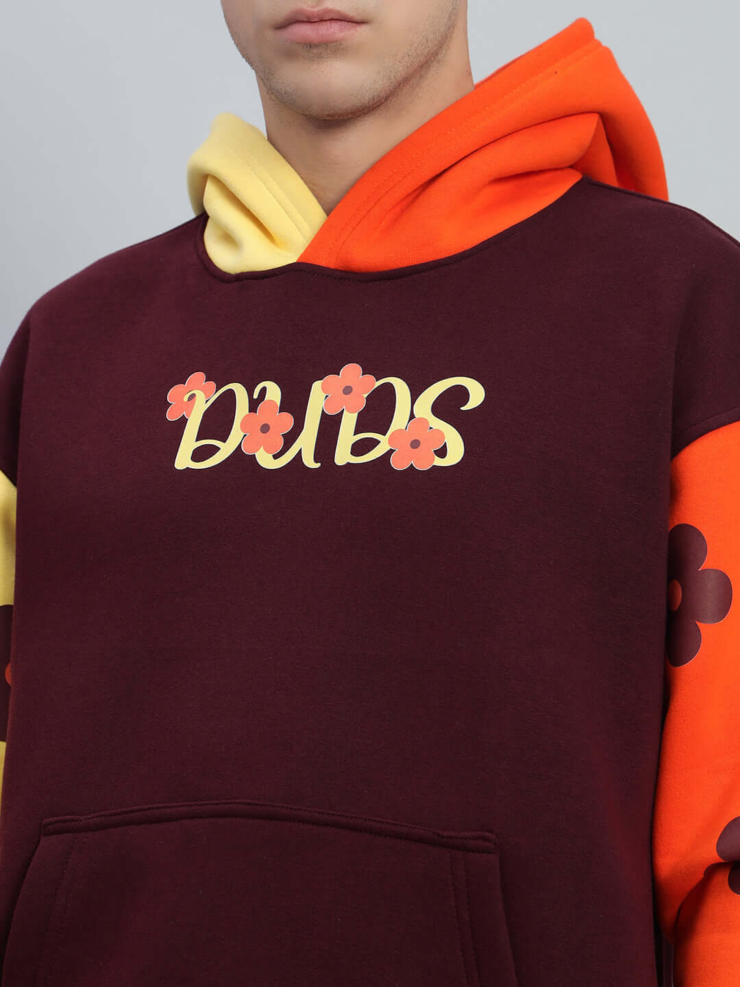 COSMOS Oversized Fleece Hoodie in multi-color with floral design and bold text, featuring vibrant orange and yellow accents.