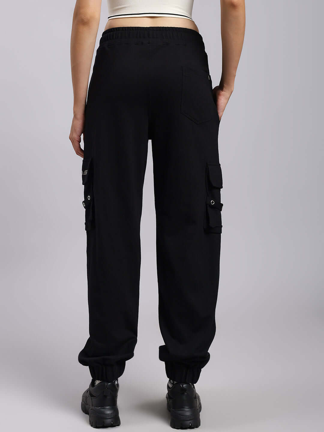 Rear view of black Women's DUDS Commando Joggers showcasing trendy cargo pockets and elastic cuffs.