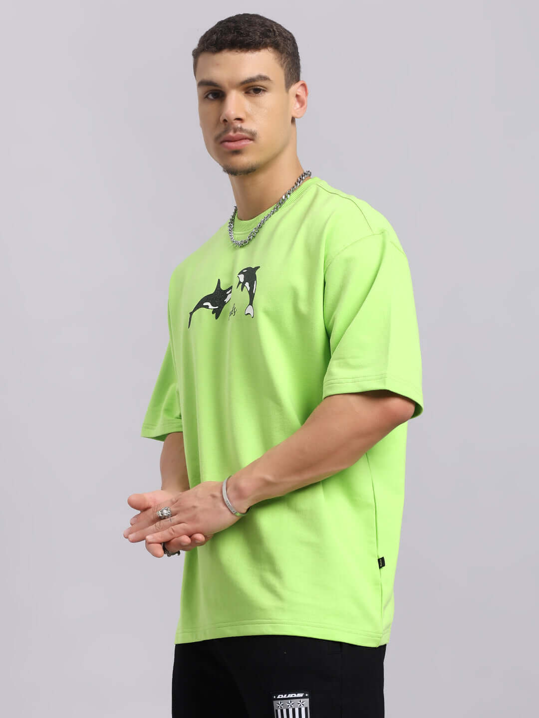Model wearing Orcas Over-Sized Neon Green T-Shirt, featuring premium cotton French terry fabric, designed by Color By Colours.