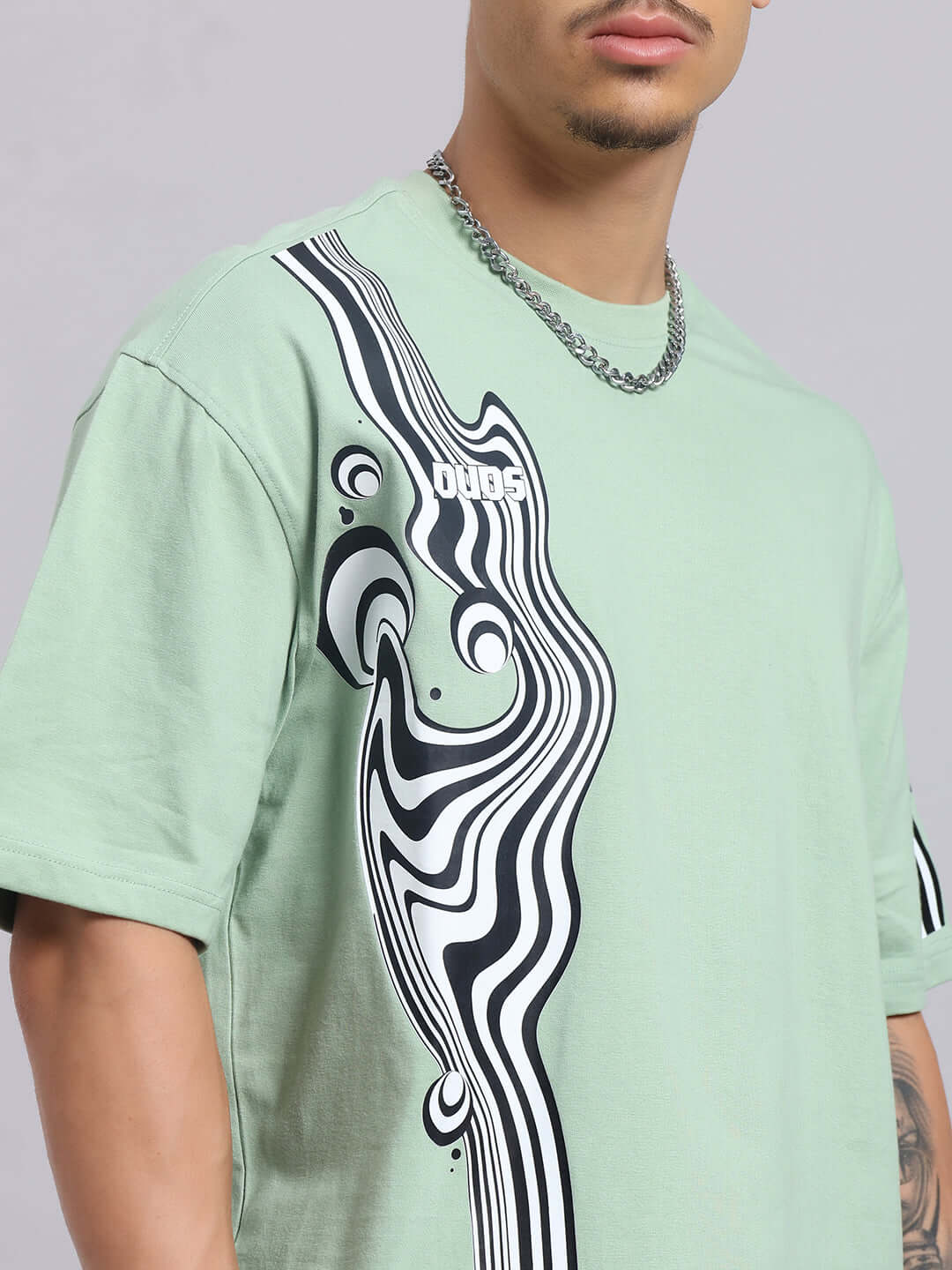 CHIMERA over-sized Nyanza green t-shirt with graphic design on premium cotton fabric, styled by a model. Ideal for casual wear.