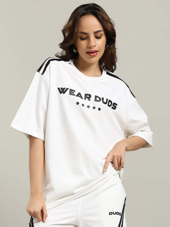Model wearing oversized off-white women's star jumper t-shirt made of premium cotton, featuring "Wear Duds" text, ideal for casual wear.