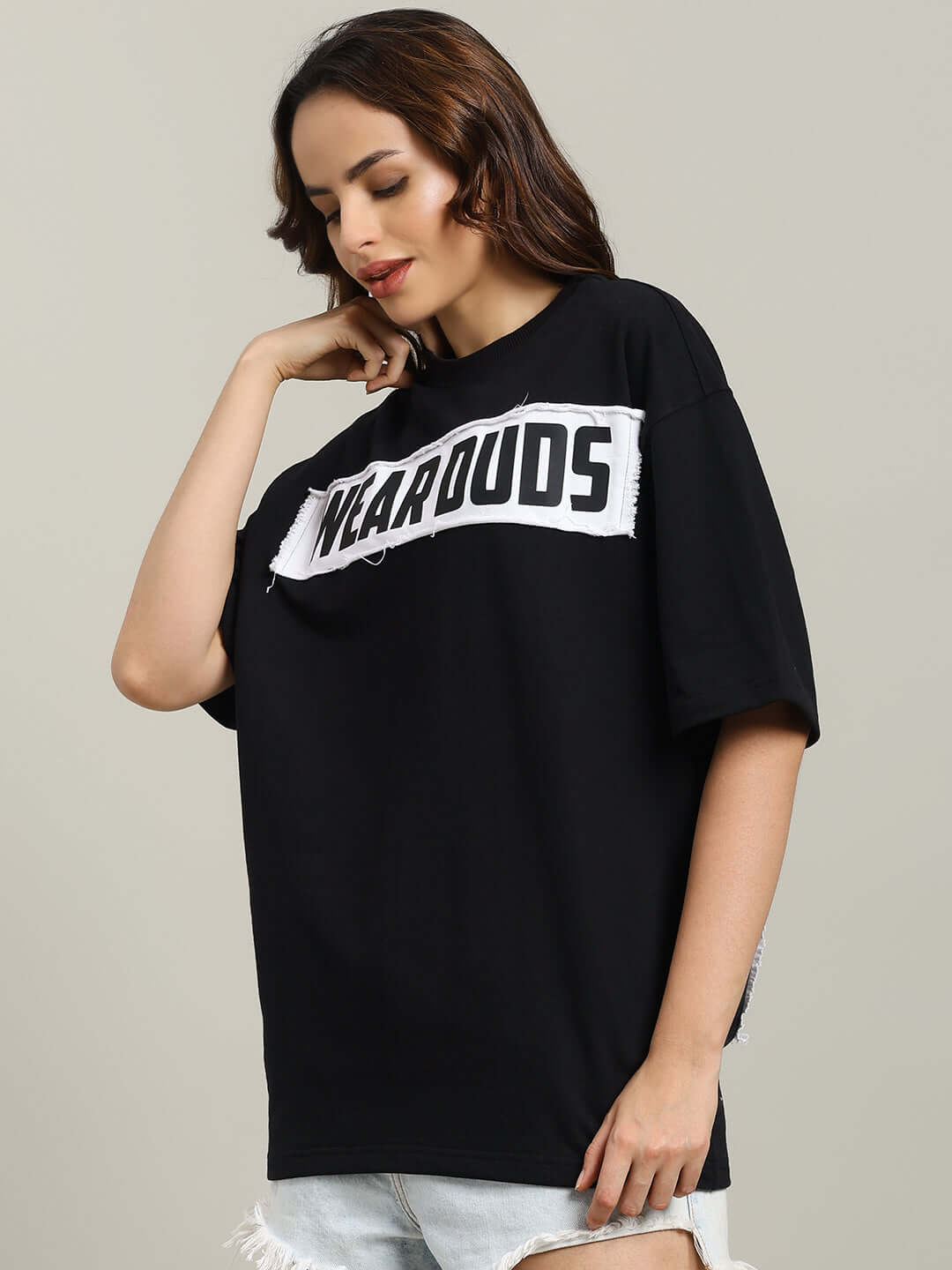 Woman wearing black oversized Harley designer T-shirt made from premium cotton with 'Wearouds' text.