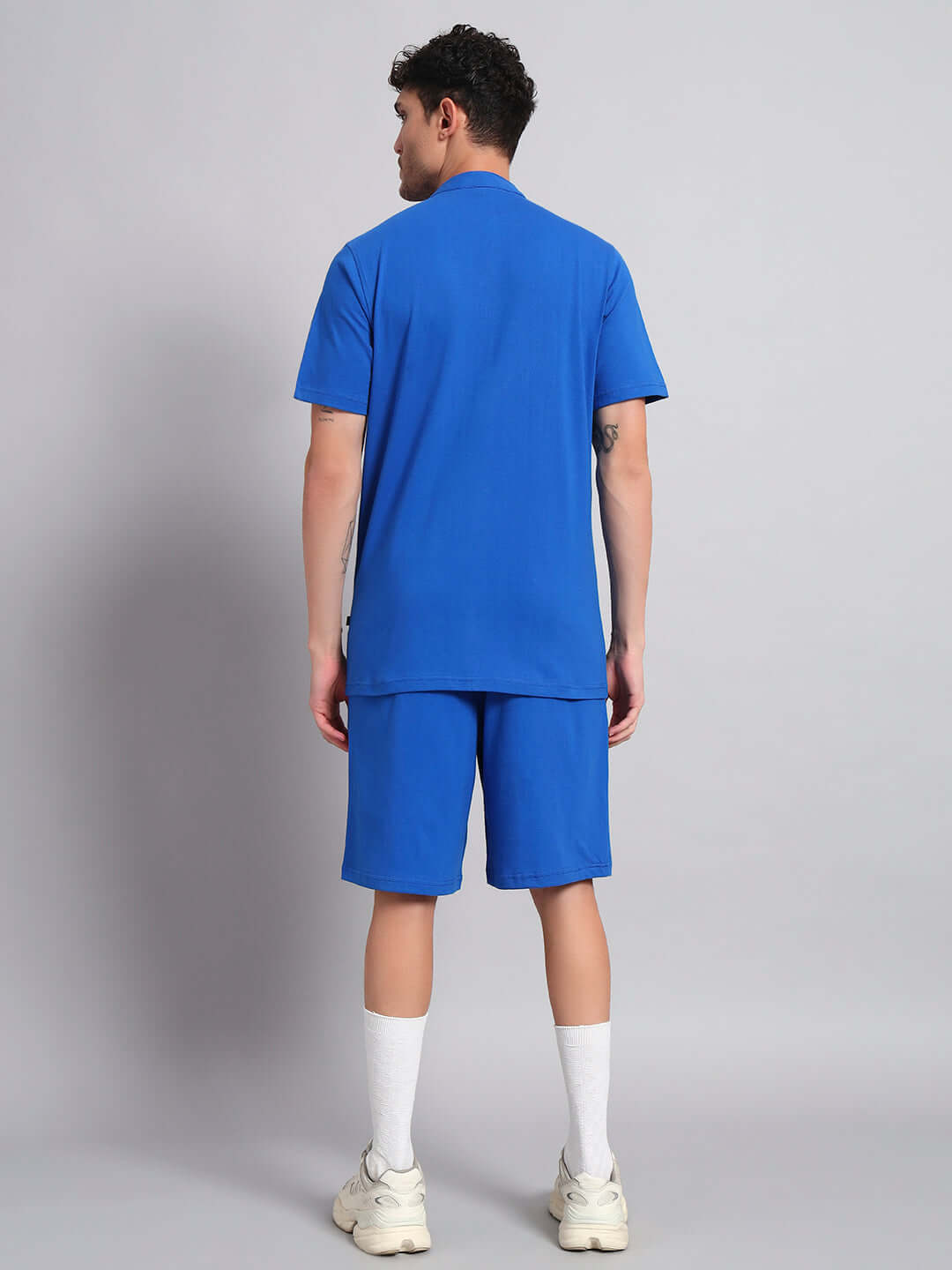 Back view of a man wearing a blue LIMBO CO-ORD SET, made of premium cotton French terry lycra, showcasing bio-washed fabric quality.