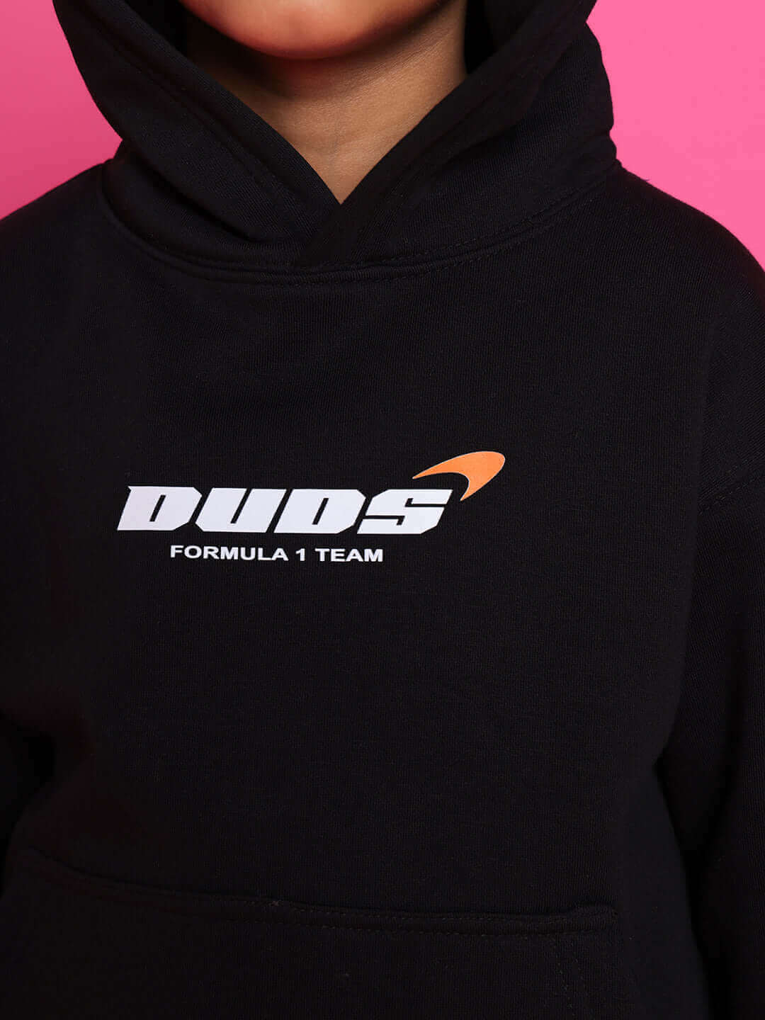 Black hoodie with "DUDS Formula 1 Team" logo worn by a child, showcasing playful and stylish design for boys and girls.