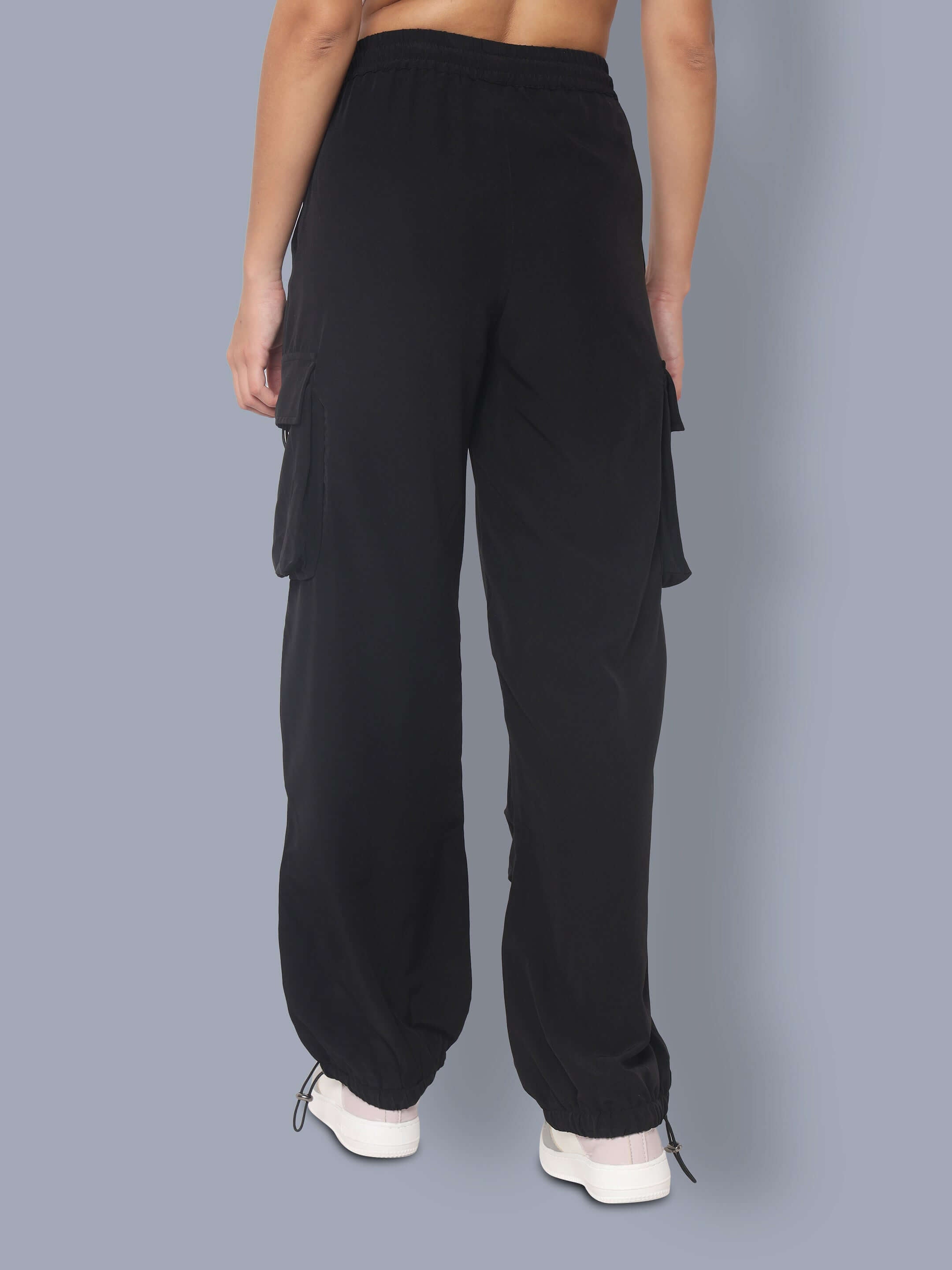 Back view of women's black tactical cargo joggers with pockets and drawstring, showcasing a comfortable and stylish fit.