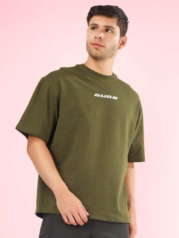 Model wearing AMOUR OVER-SIZED T-SHIRT OLIVE GREEN made from premium heavy gauge fabric, featuring 97% cotton and 3% elastane.