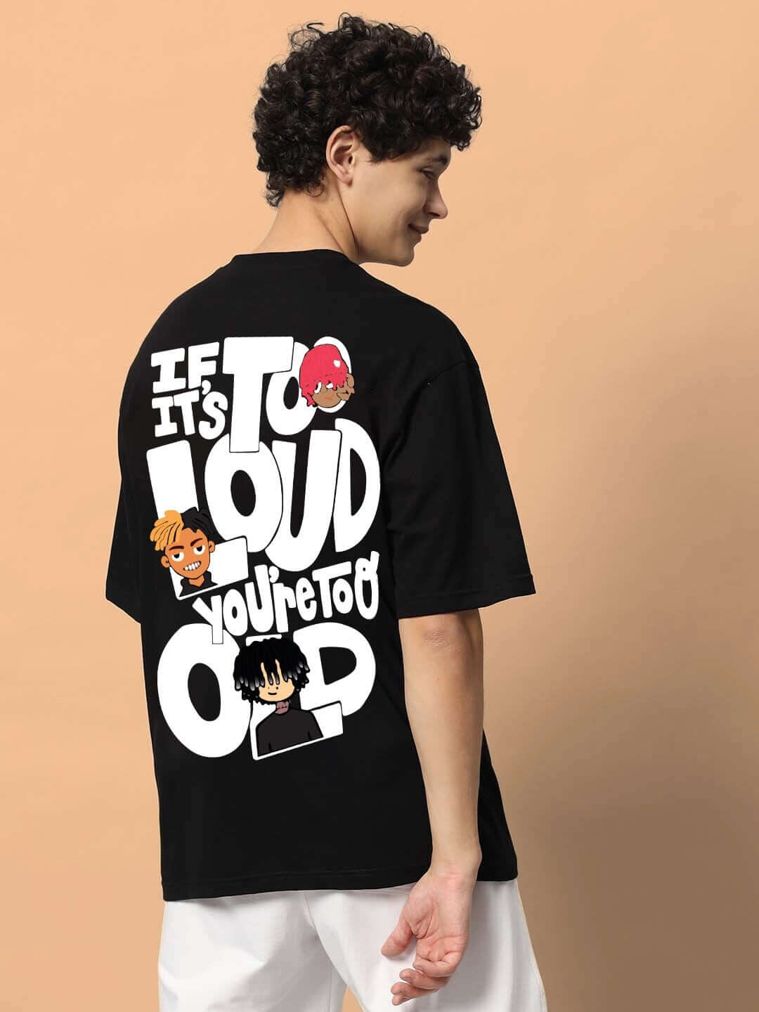 Person wearing TOO LOUD OVER-SIZED T-SHIRT BLACK with bold graphic on the back.