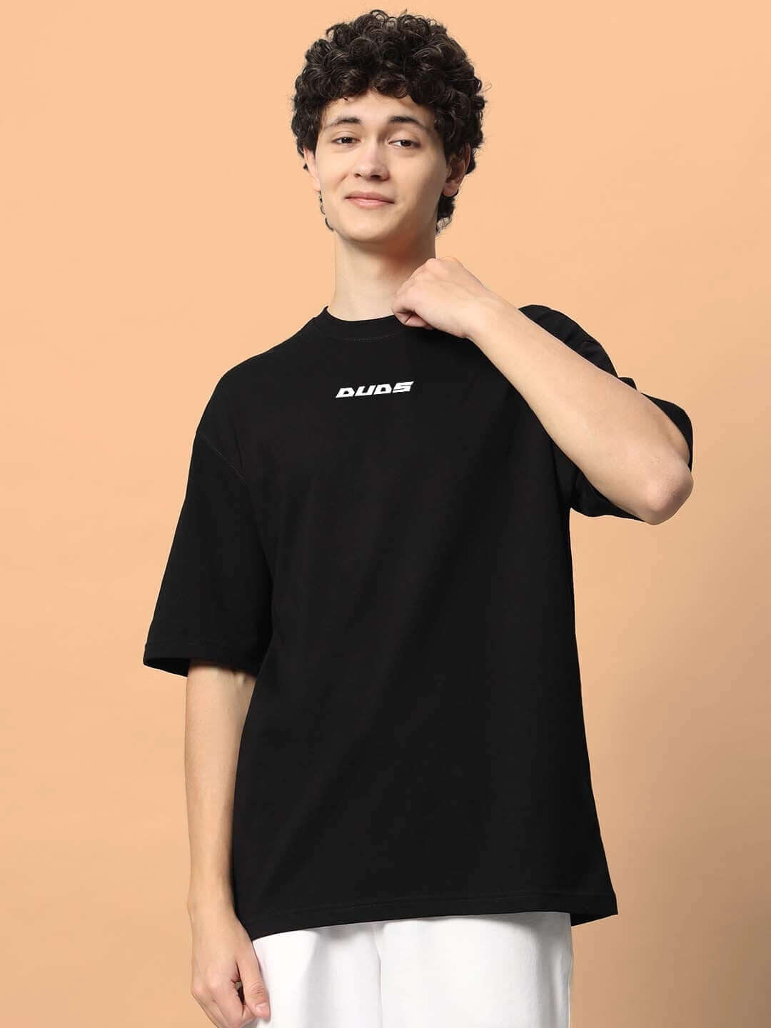 Model wearing TOO LOUD OVER-SIZED T-SHIRT BLACK with DUDS logo, customizable fit option available for prepaid orders.