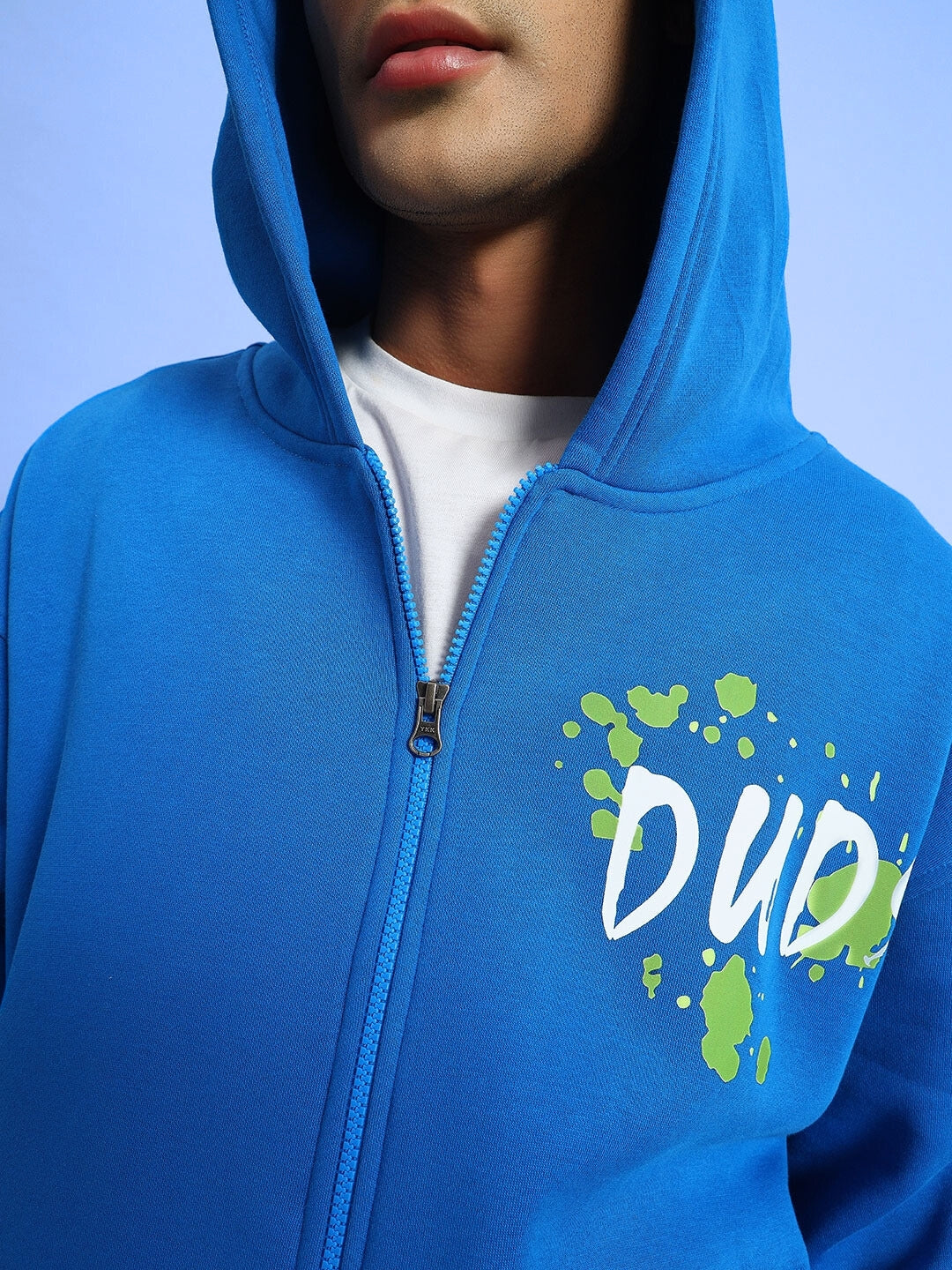 Close-up of a blue hoodie with 'DUO' design, featuring a zip closure and hood, made from comfy cotton fleece. Perfect casual wear.