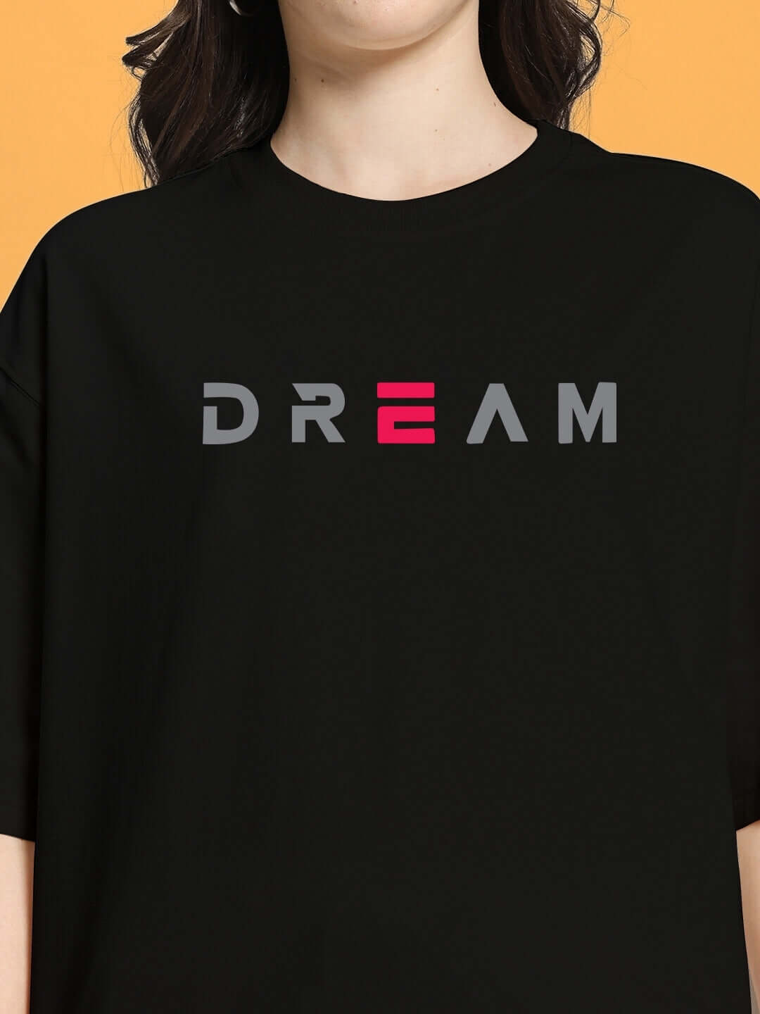 Women's over-sized black t-shirt with 'DREAM' print, made from premium heavy gauge cotton fabric. Perfect casual wear.