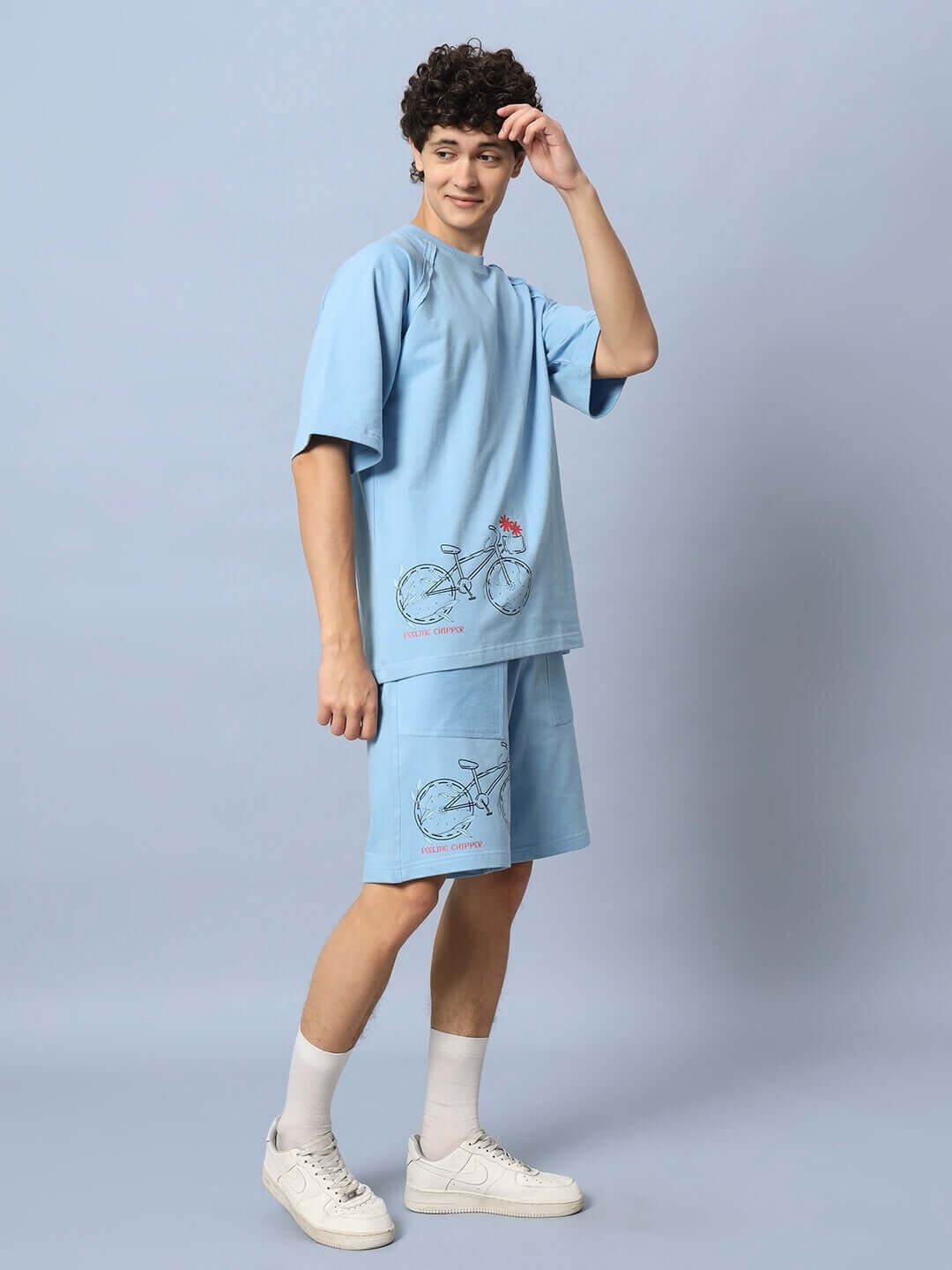 Model wearing ENJOY THE RIDE PRINTED CO-ORD SET BLUE, featuring premium heavy gauge fabric and cotton terry, stylish bicycle print.