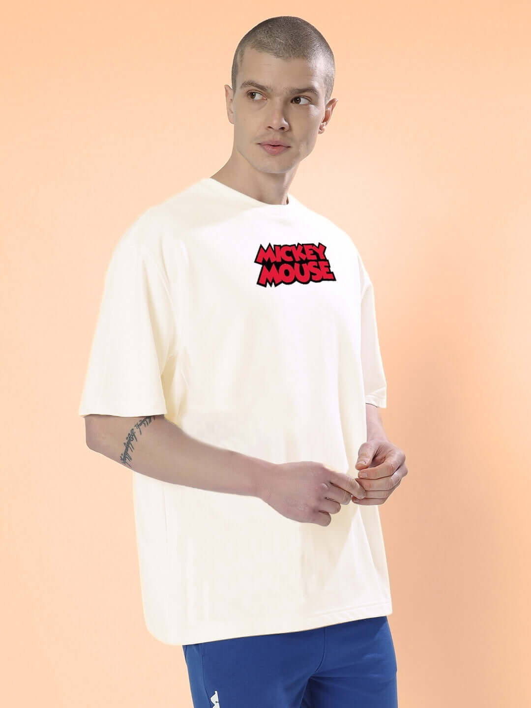 Man wearing DUDS MOUSE OVER-SIZED T-SHIRT OFF WHITE with logo, perfect for casual wear. Available with custom fit option.