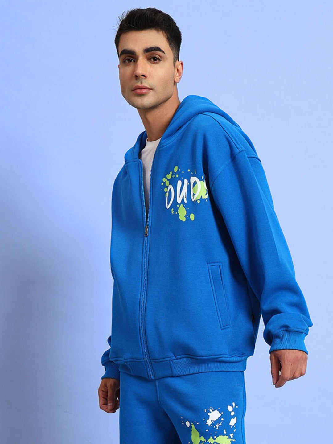 Man wearing No Drama cotton fleece hoodie in vibrant royal blue with colorful graphic print, perfect casual wear for comfort and style.