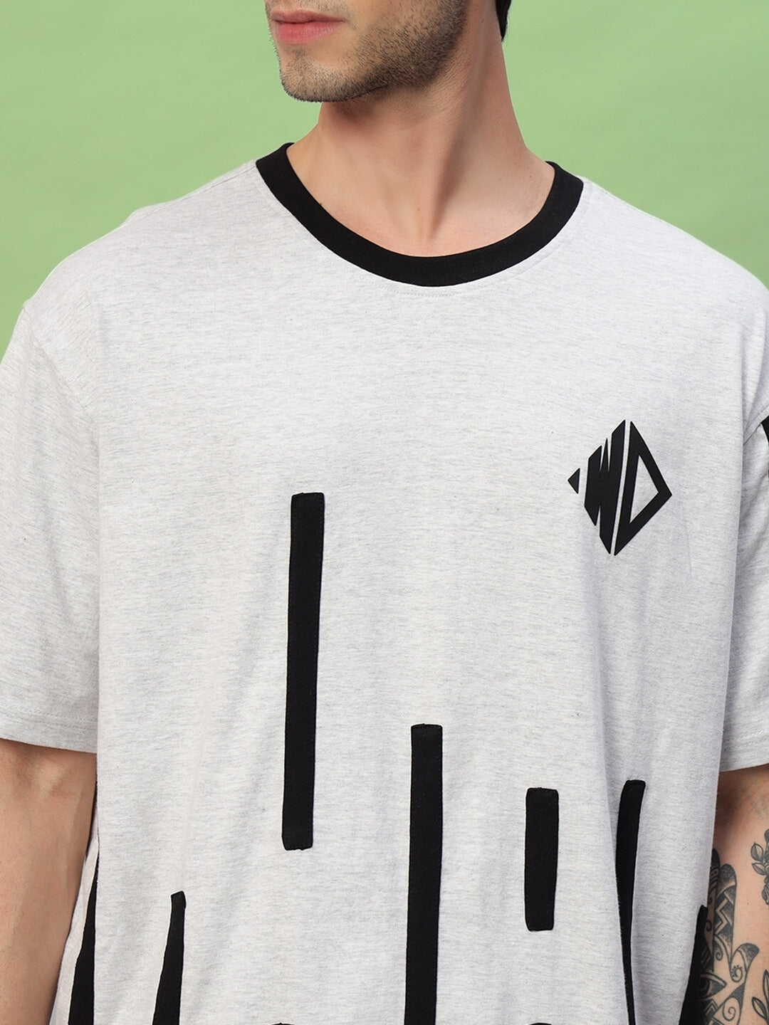 Model wearing Bastille Oversized T-Shirt in melange grey with black geometric pattern.