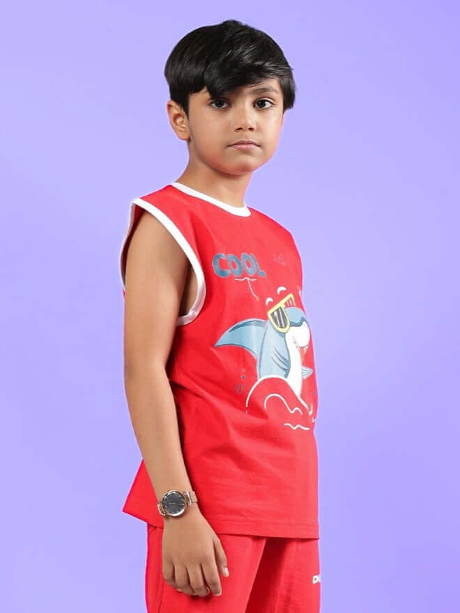 Child wearing a red Shortfin T-shirt, showcasing a cool shark design, suitable for both boys and girls, against a purple background.