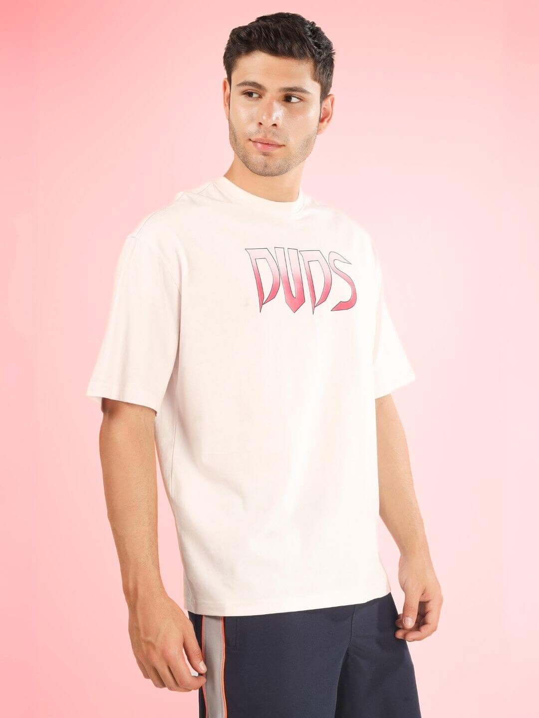 Model wearing CRUEL OVER-SIZED T-SHIRT BABY PINK by DUDS, displaying classic casual look with custom fit option available.