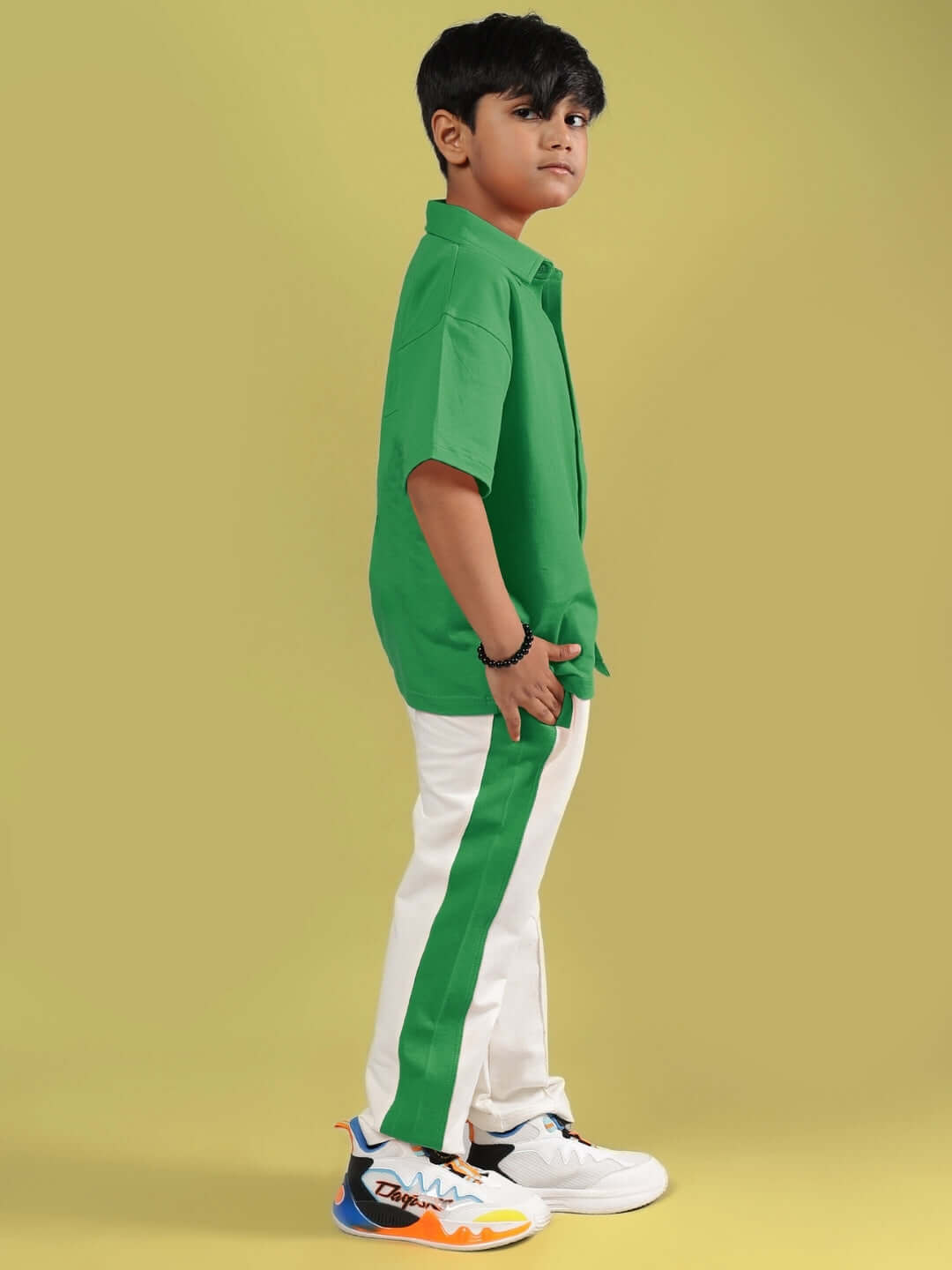 Child wearing green off-white Angry Sponge co-ord, side view. Perfect outfit for boys and girls. Custom fit available. Made by DUDS.