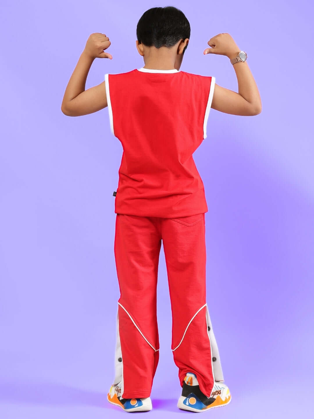 Child wearing a vibrant red Shortfin T-shirt and pants set, showcasing a playful design suitable for boys and girls.