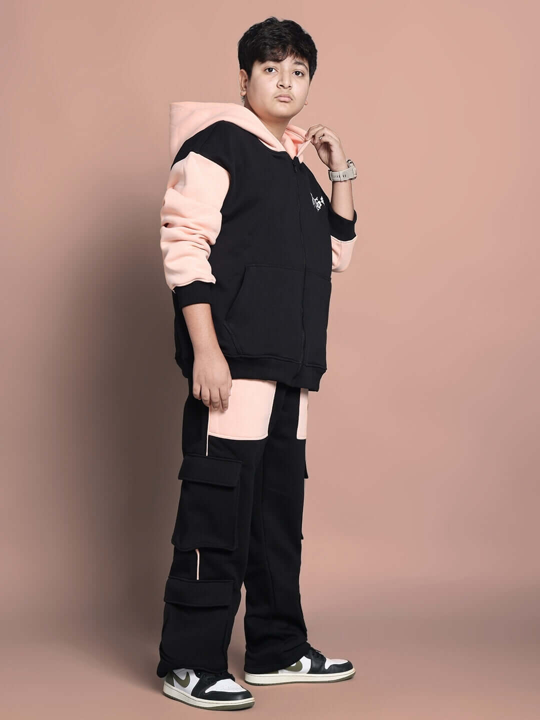 Child wearing a stylish black-beige Angel Wings co-ord set, featuring a hoodie and pants, perfect for boys and girls.