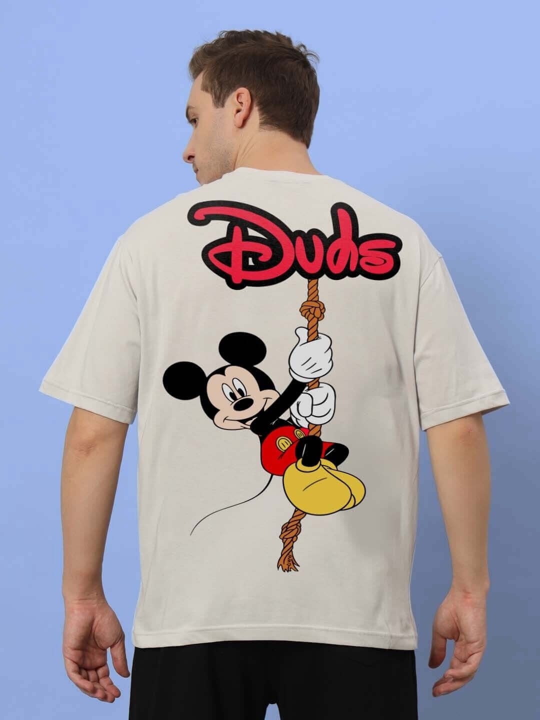 Back view of a person wearing DUDS MOUSE OVER-SIZED T-SHIRT GREY featuring a cartoon design.