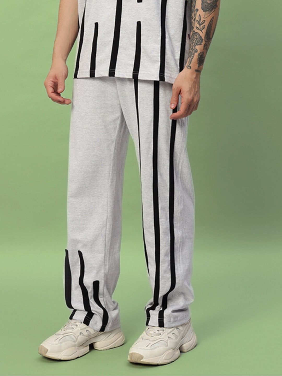 Model wearing Bastille Jogger in melange grey with vertical black stripes, made-to-order by DUDS, customizable for custom fit.