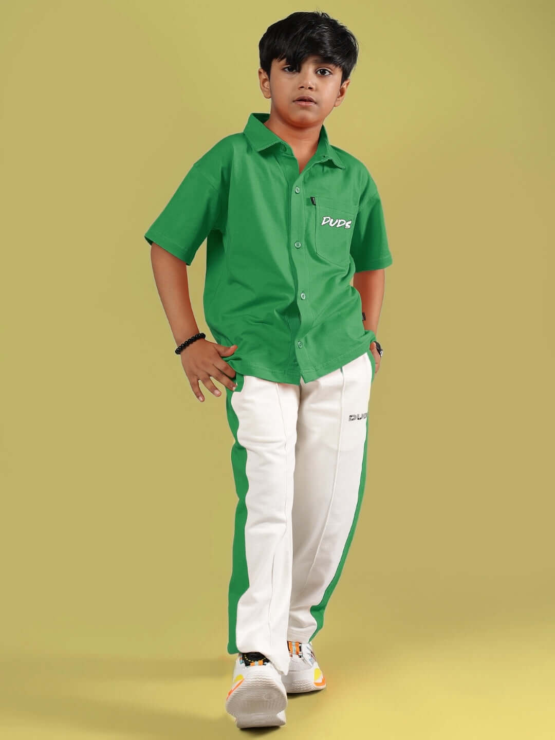 Boy wearing ANGRY SPONGE green-off-white co-ord set from DUDS, available for custom fit and pre-order.