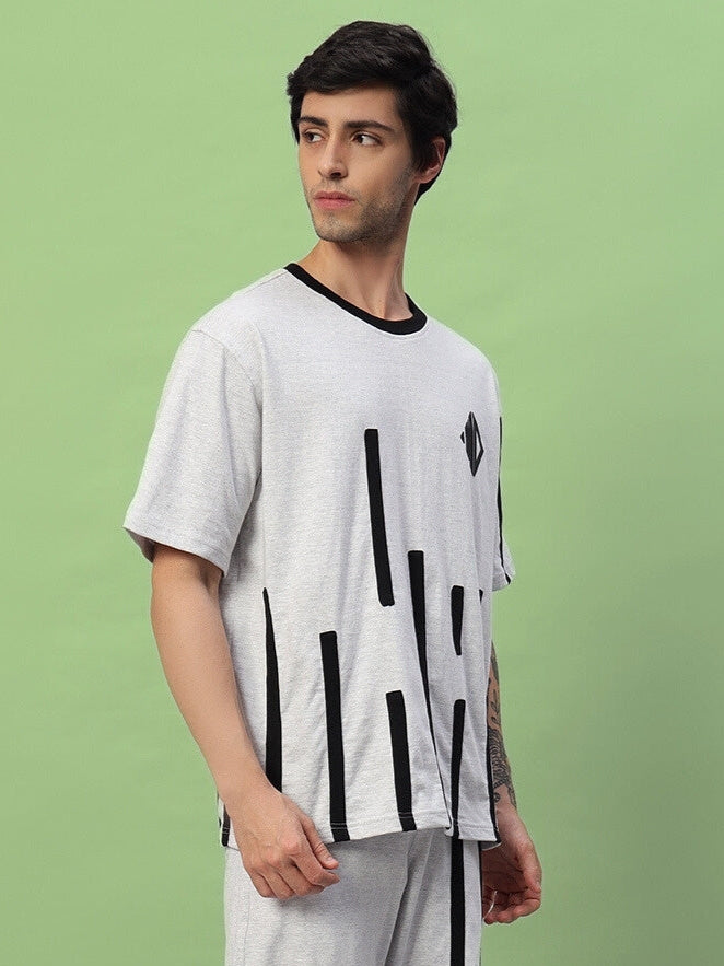 Model wearing BASTILLE oversized melange grey T-shirt made from premium cotton French Terry Lycra blend, ideal for casual wear.