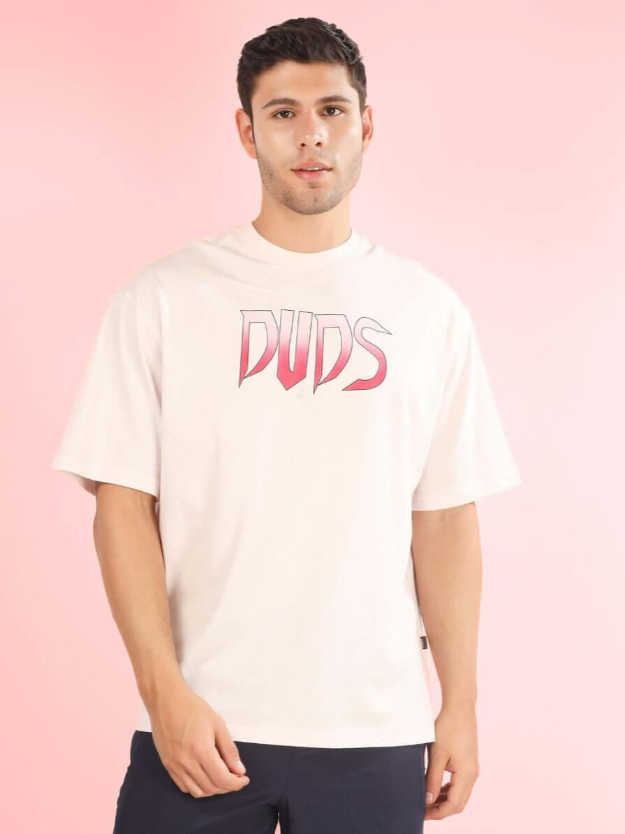 Model wearing CRUEL OVER-SIZED T-SHIRT BABY PINK by DUDS against pink background