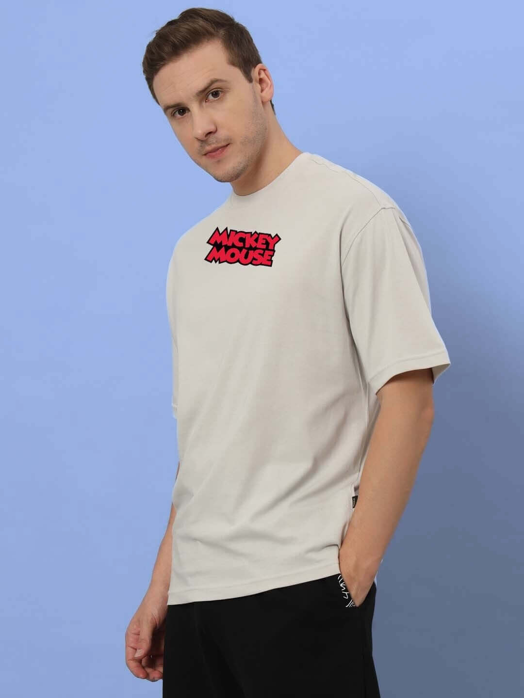 Person wearing DUDS MOUSE OVER-SIZED T-SHIRT GREY with Mickey Mouse logo.