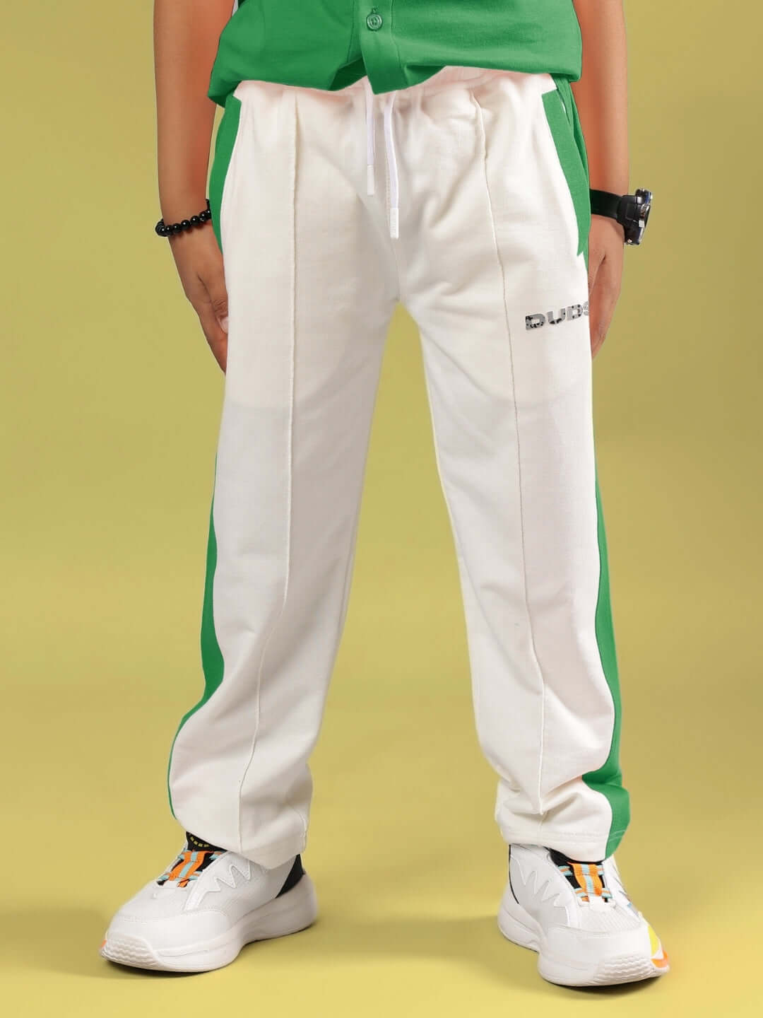 Child wearing ANGRY SPONGE CO-ORD, green and off-white pants, by DUDS, showcasing custom fit option for boys and girls.
