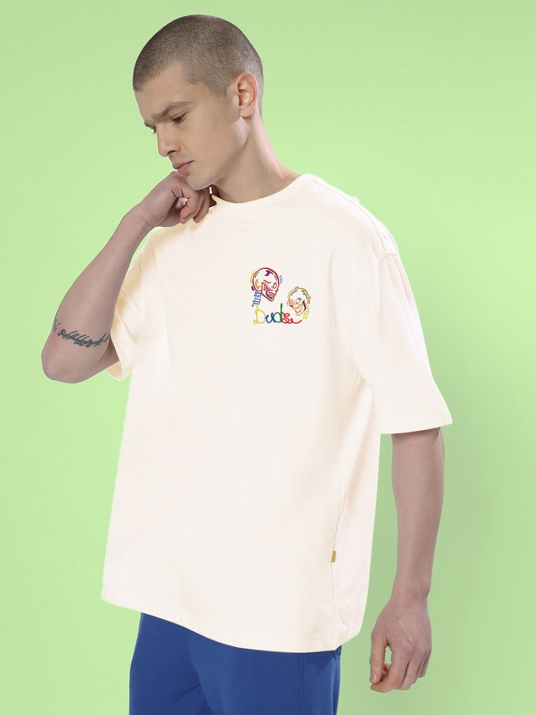 Person wearing SKULL ROLL OVERSIZED T-SHIRT OFF WHITE with skull design