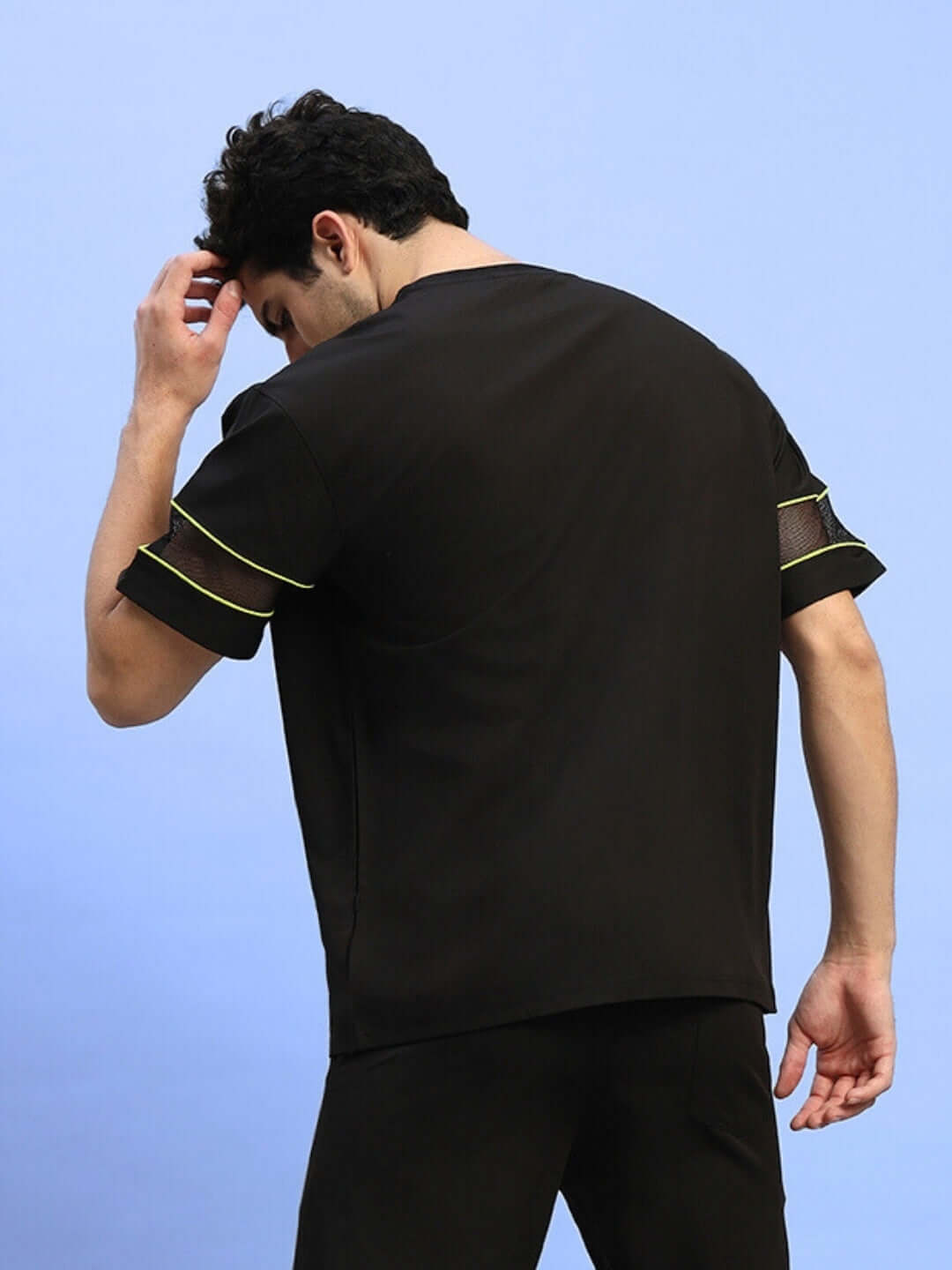 Back view of a person wearing a black Salvo Reflector Regular Fit T-Shirt made from sports polyester fabric.
