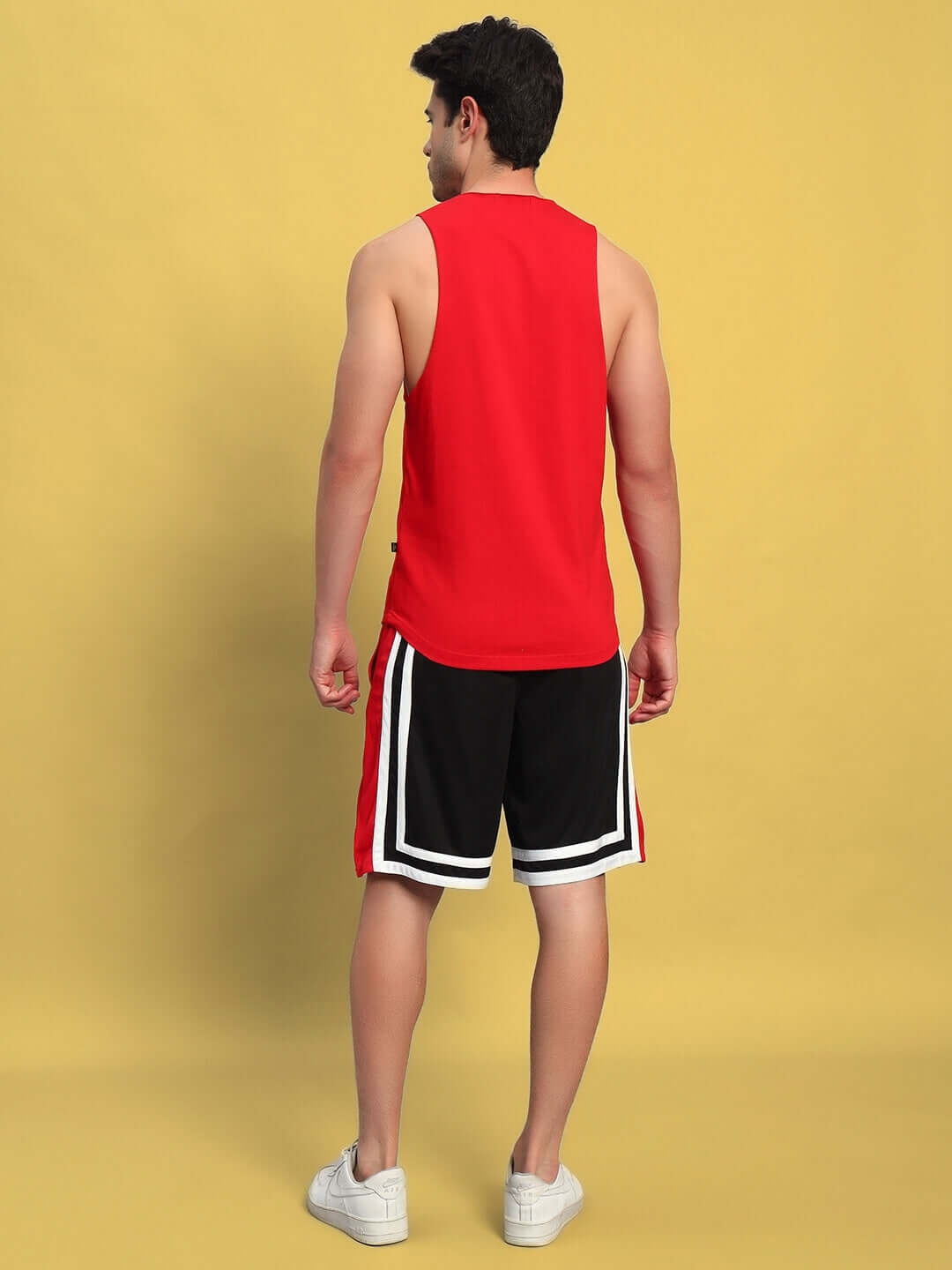 Man wearing MAX Gym Co-Ord Set in red and black, featuring a cotton vest and polyester shorts, perfect for workouts.