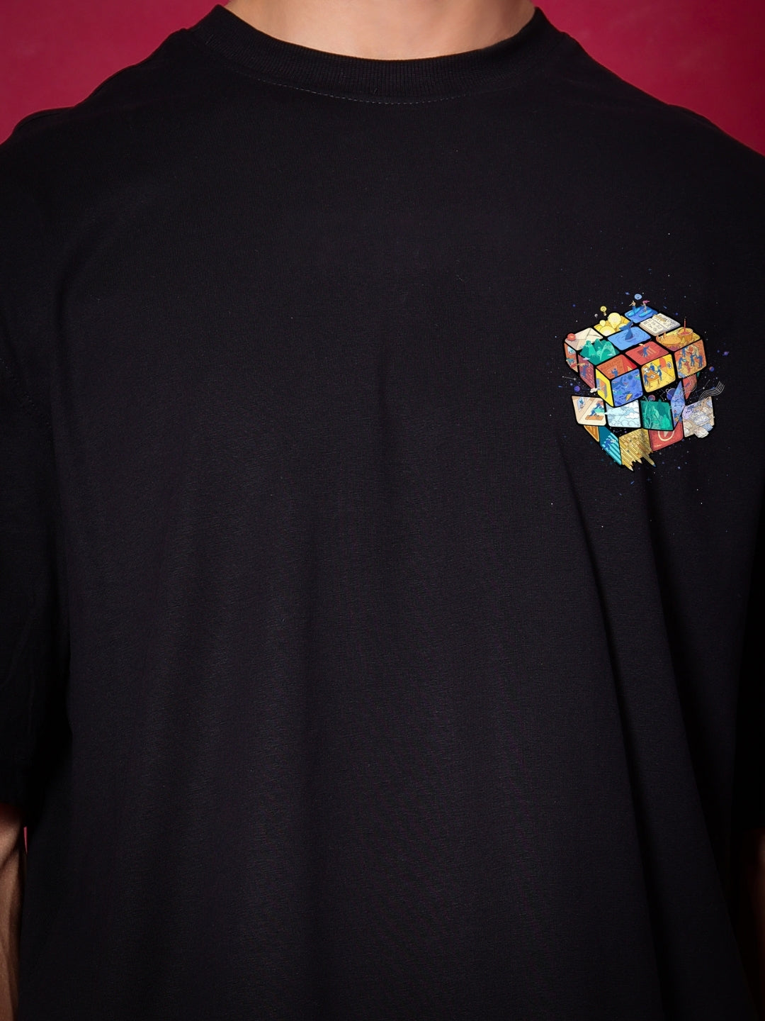 RUBIK REVOLUTION OVERSIZED T-SHIRT BLACK with colorful cube design on front, customizable fit available for prepaid orders.
