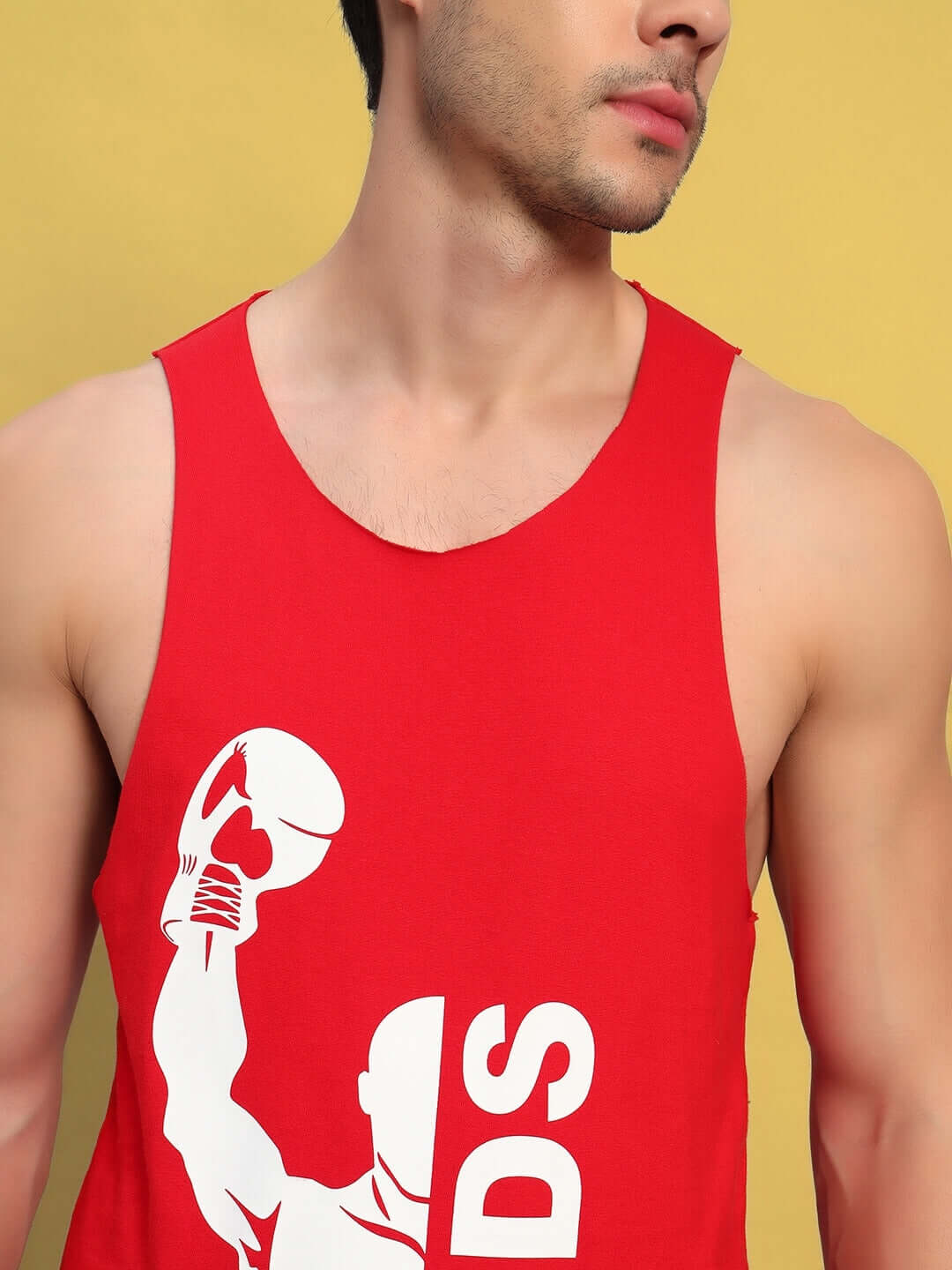 Man wearing red tank top from MAX GYM CO-ORD SET with bold graphic on chest. Ideal for gym wear, featuring cotton terry fabric.