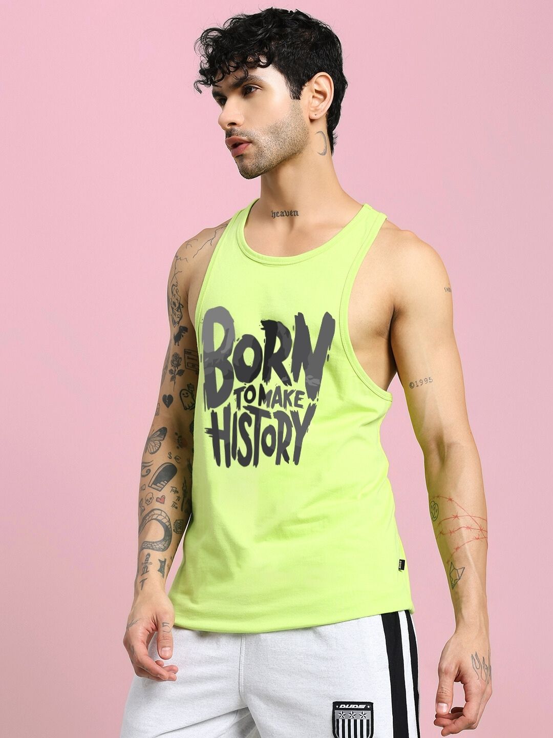 Model wearing BORN TO MAKE HISTORY GYM VEST T-SHIRT NEON GREEN with motivational text.