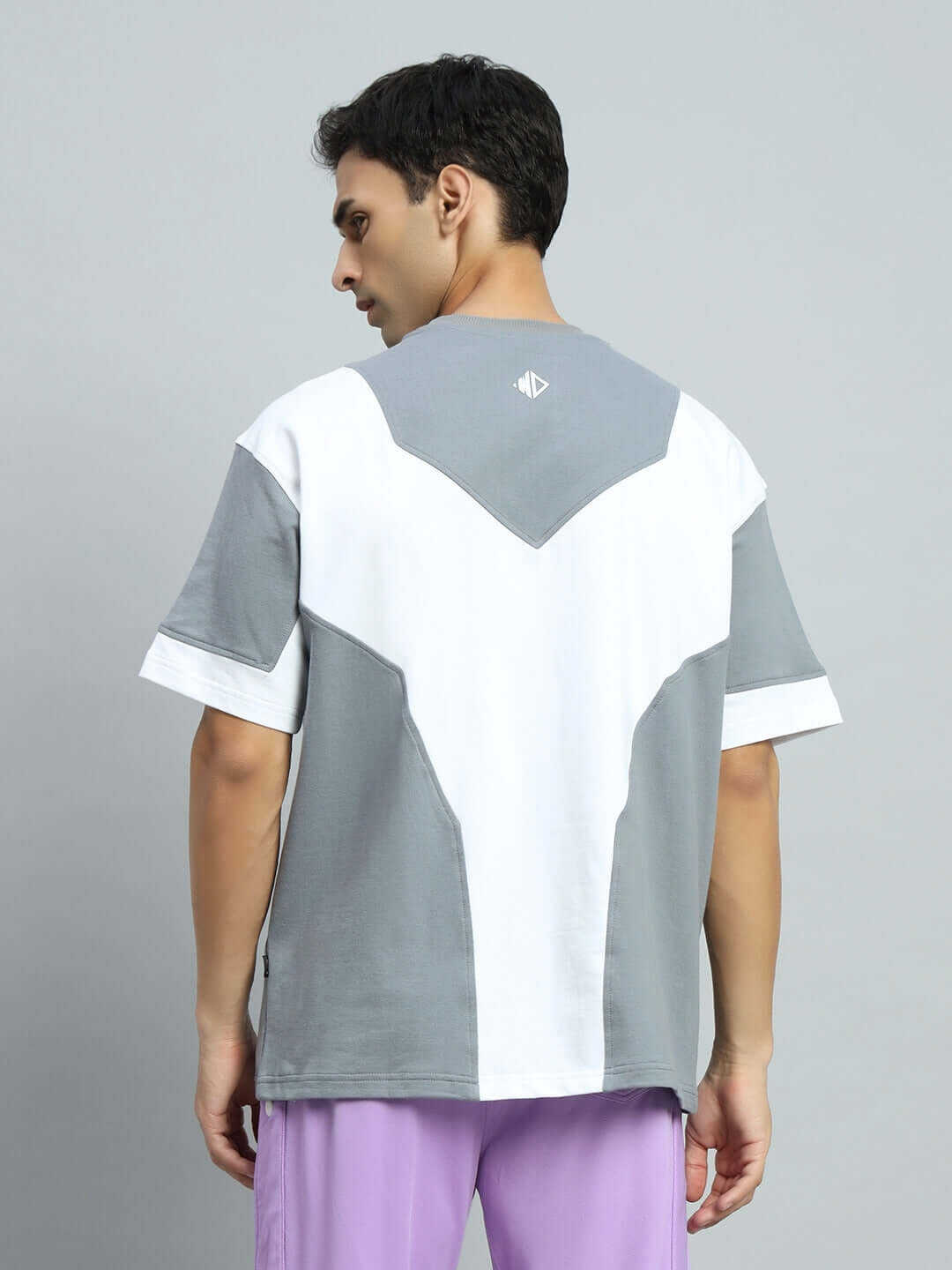 Man wearing SPHERE OVER-SIZED T-SHIRT GREY WHITE, showcasing the back design with premium heavy gauge fabric.