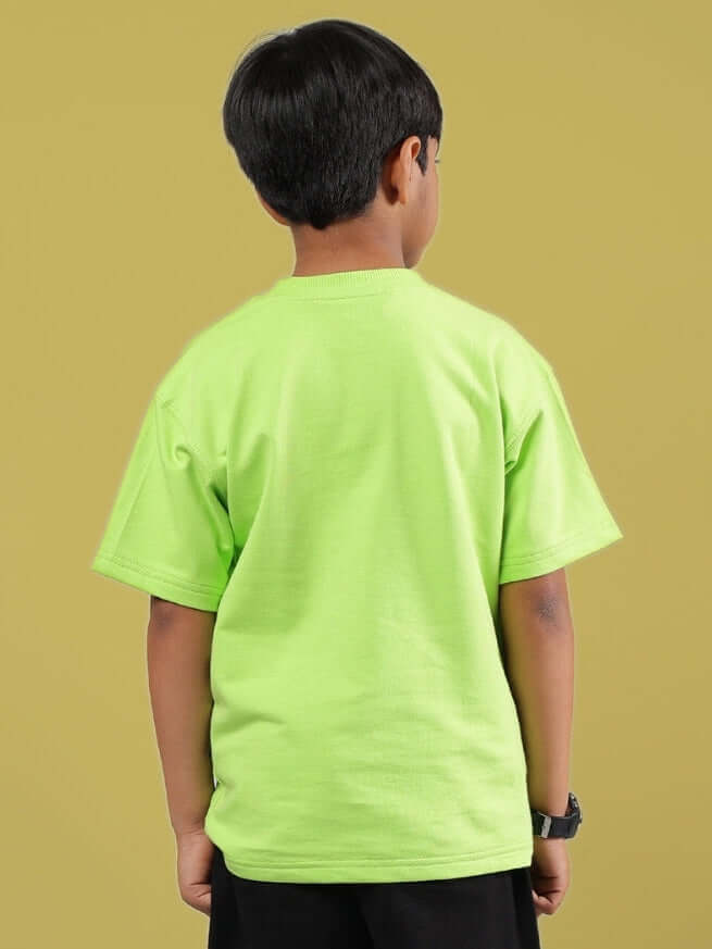 Child wearing a muffin oversized neon green T-shirt from DUDS, showcasing a comfortable fit and vibrant color.