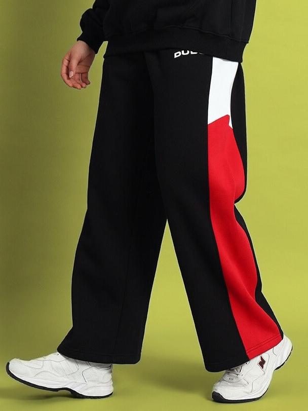 Black women's colorblock cargo pants with red and white detail, relaxed fit, streetwear style.