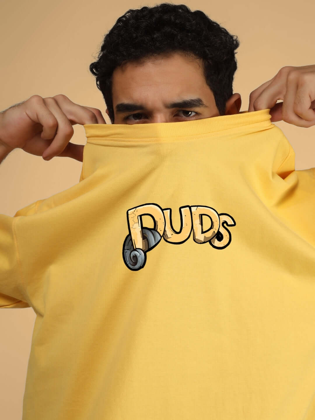 Person wearing DUCK TALES OVER-SIZED T-SHIRT YELLOW with 'DUDS' logo visible on the shirt.