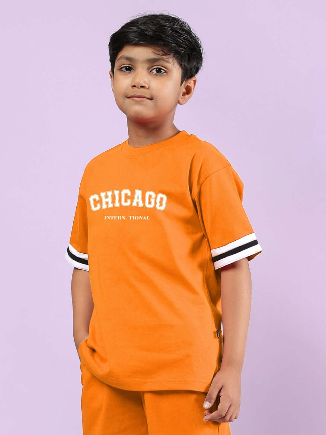 Orange Chicago printed t-shirt for boys and girls by DUDS, featuring a sporty design with black and white sleeve accents.