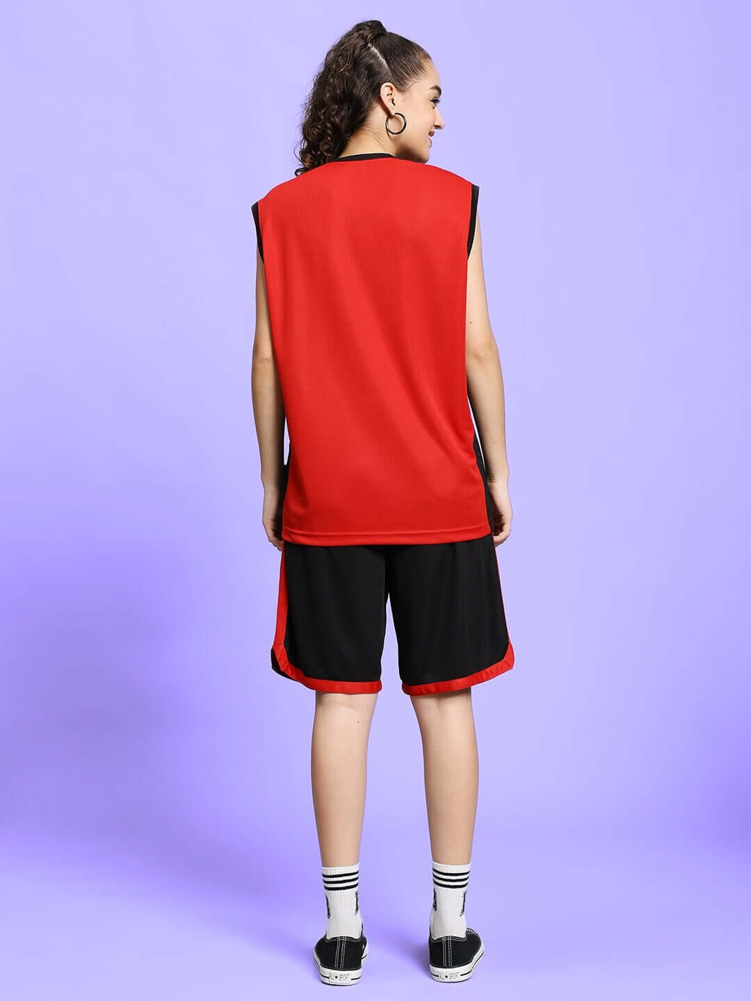 Back view of a woman wearing a red-black gym co-ord set, featuring a sleeveless top and matching shorts, ideal for workouts.