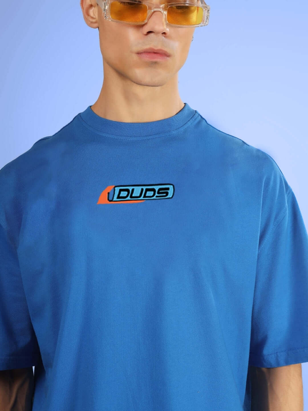 Man wearing ROBO SHARK OVER-SIZED T-SHIRT ROYAL BLUE showing logo on chest.