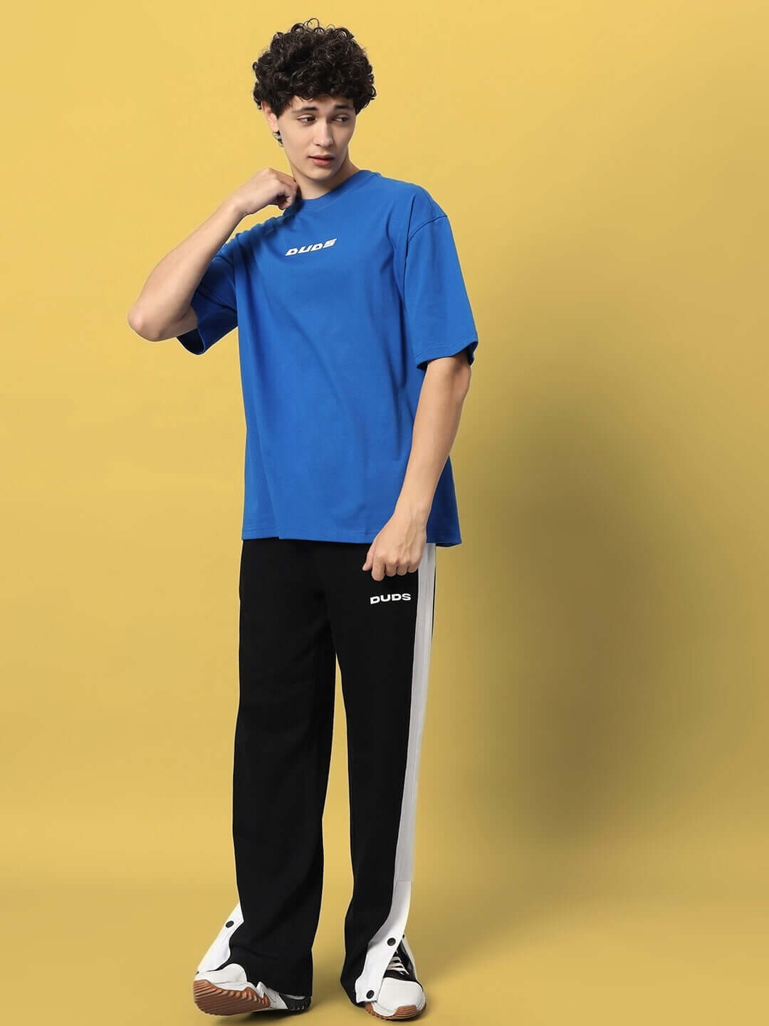 Model wearing VICTORY OVER-SIZED T-SHIRT ROYAL BLUE with casual pants.