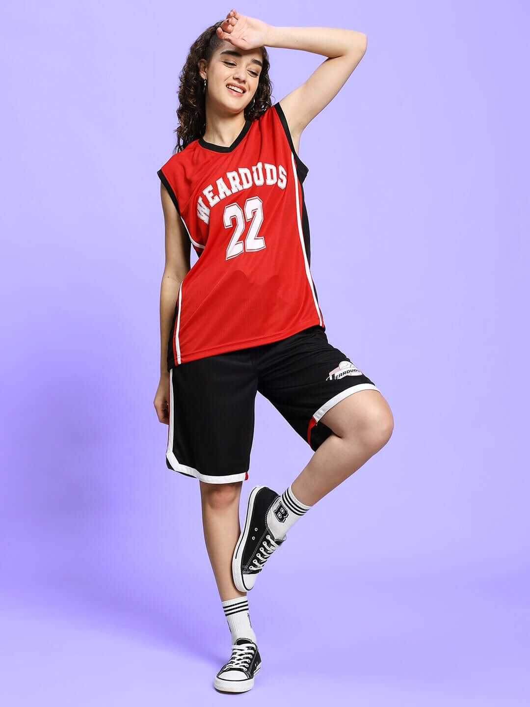 Red-black gym co-ord set with sleeveless top and shorts, made from sports polyester, suitable for fitness activities, worn by a model.