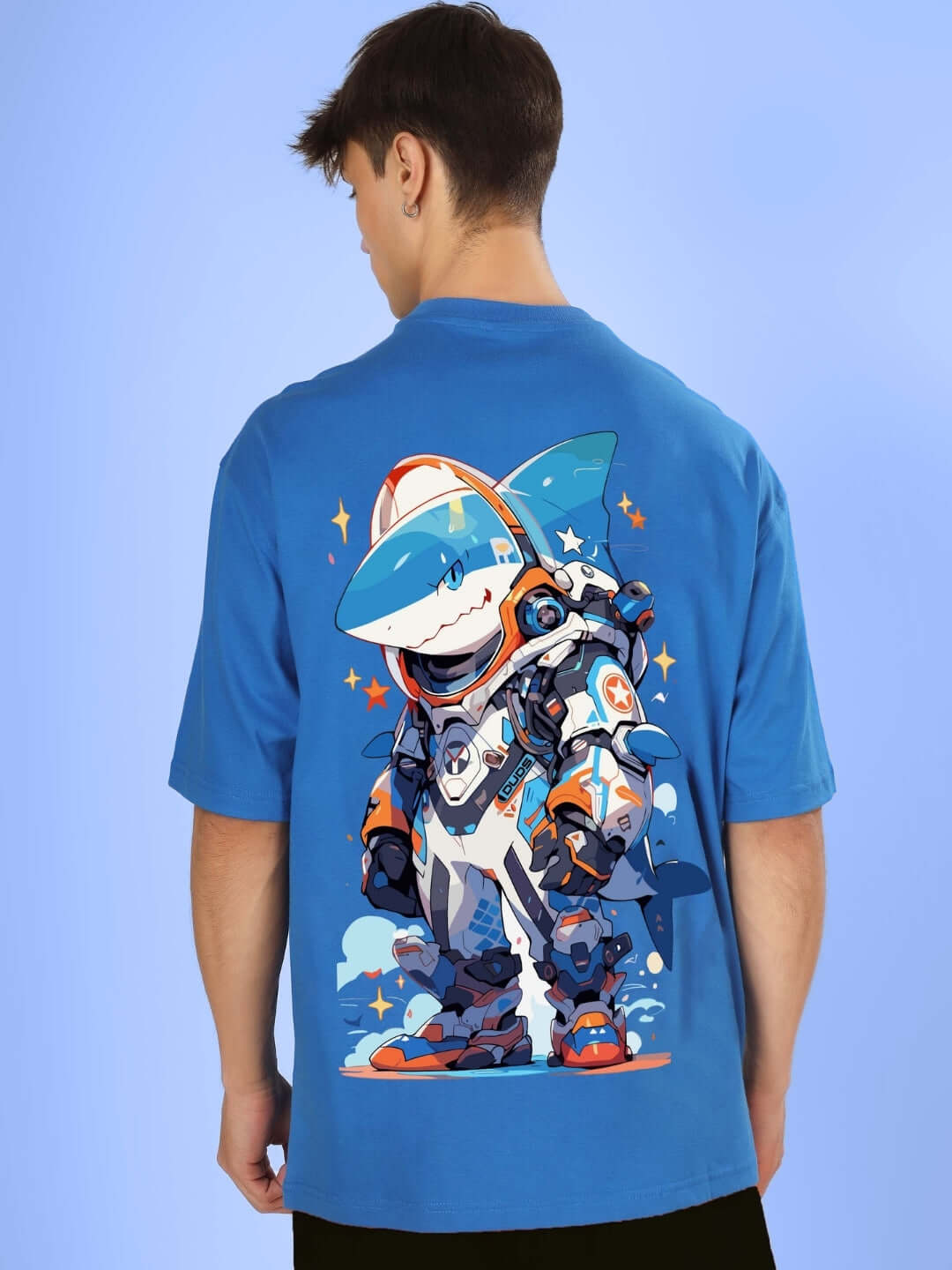 Man wearing ROBO SHARK OVER-SIZED T-SHIRT ROYAL BLUE featuring a robot-shark graphic on the back.