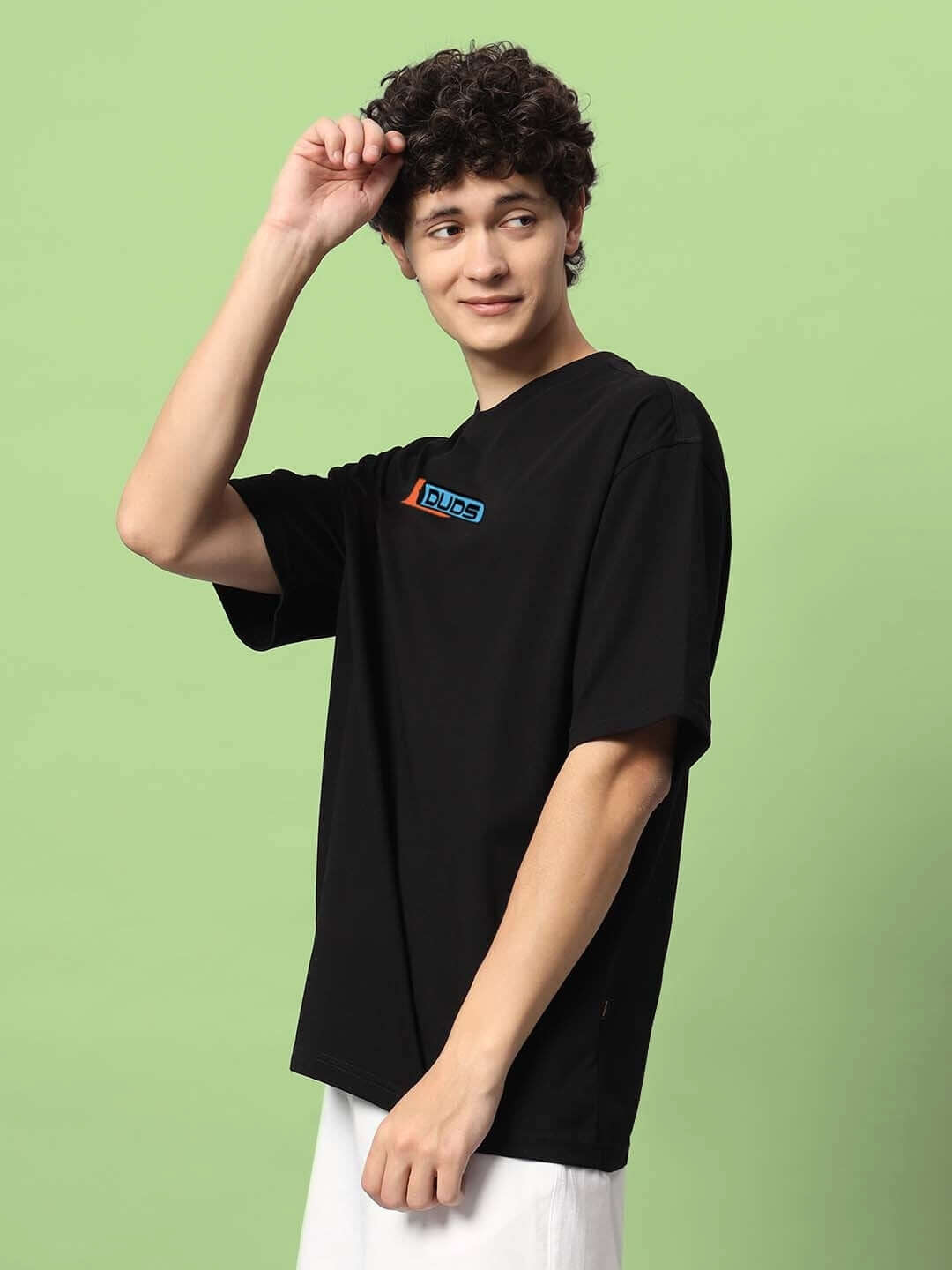 Person wearing ROBO SHARK OVER-SIZED T-SHIRT BLACK made from premium cotton French terry and elastane, ideal for stylish casual wear.