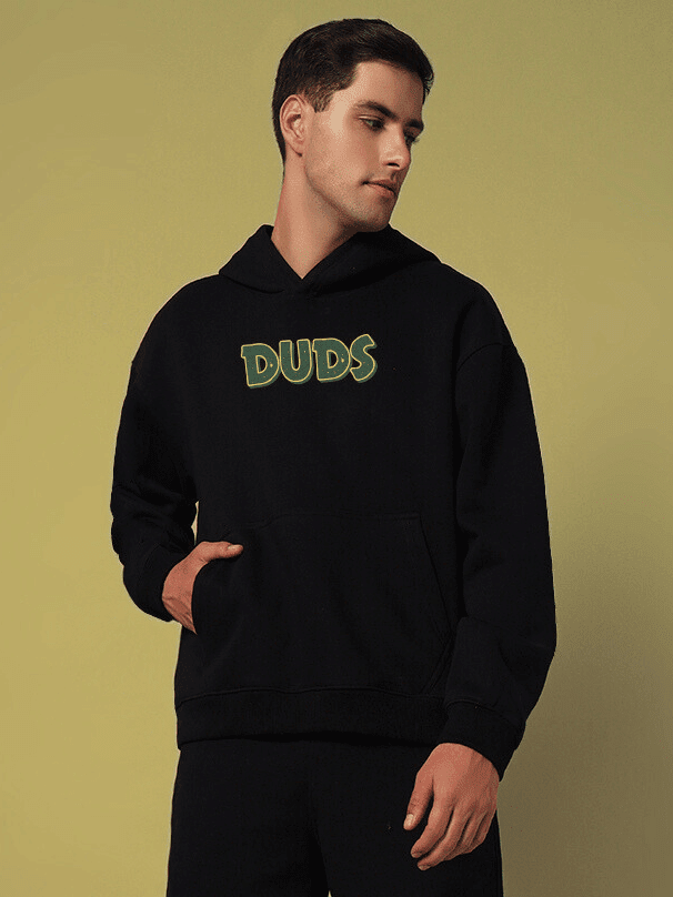 Man wearing JUDY NICK ZOOTOPIA FLEECE HOODIE BLACK with cartoon nostalgia and streetwear style.