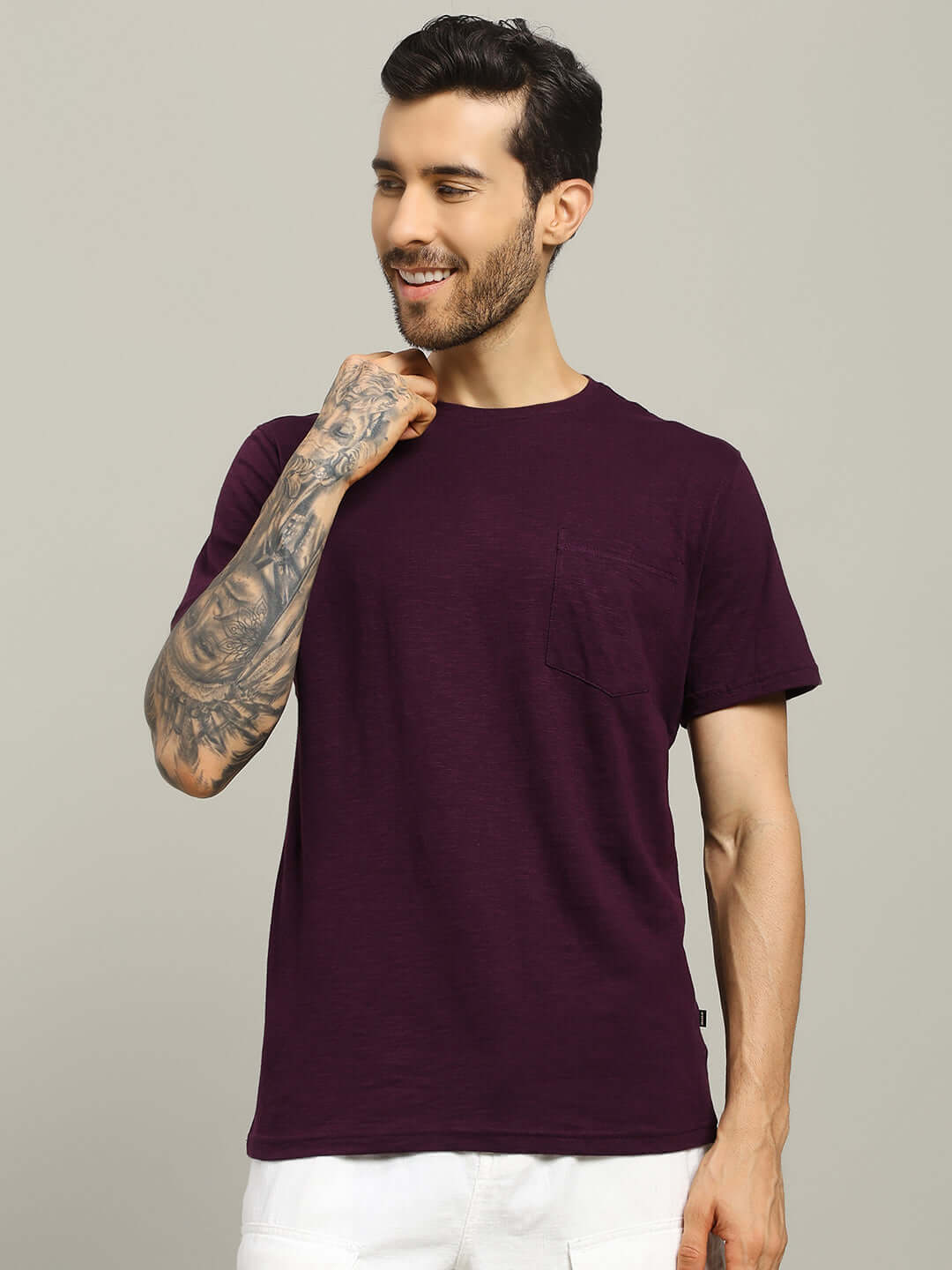 Man wearing JOY Regular Fit T-Shirt in purple premium heavy cotton slub fabric, posing confidently with a smile on a neutral background.