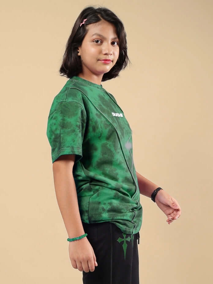 Child wearing green Ghost Rider tie-dye t-shirt, side view.
